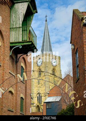 St Leonard & St Mary Catholic Church seen through the arched sign of The Maltings on Castlegate. Malton, North Yorkshire, UK. Stock Photo