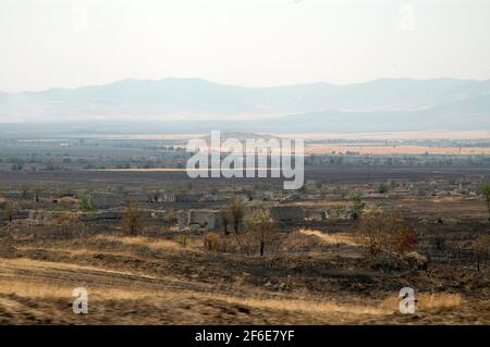 Deserted landscape with bombed houses in Nagorno Karabakh. Following the collapse of Soviet Union the war erupted between Armenia and Azerbaijan over Stock Photo