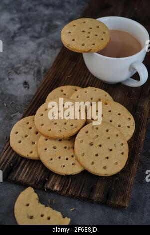 Homemade Indian Atta biscuits - Whole wheat cookies served with tea, selective focus Stock Photo