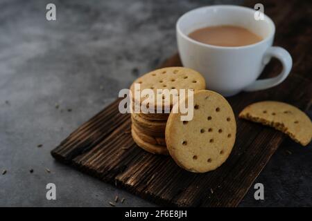 Homemade Indian Atta biscuits - Whole wheat Cumin cookies served with tea, selective focus Stock Photo