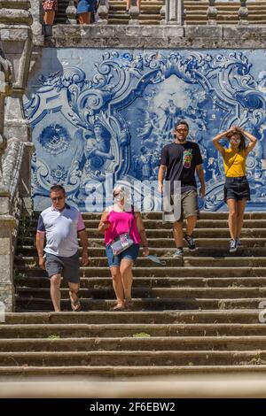 Lamego / Portugal - 07 25 2019 : View of young tourist couple and senior tourist couple walking down stairs of Lamego Cathedral Stock Photo