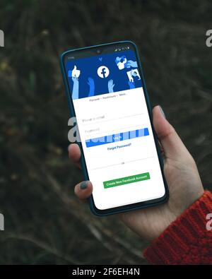 Podolsk, Ukraine - March 29, 2021: Close up photo of smartphone with Facebook profile account page on a screen. Stock Photo