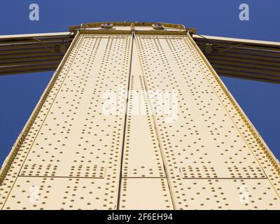 Abstract view looking up at yellow steel bridge in Pittsburgh PA Pennsylvania Stock Photo
