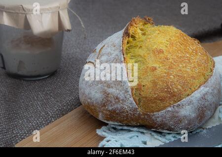 Turmeric sourdough bread with starter on the side Stock Photo