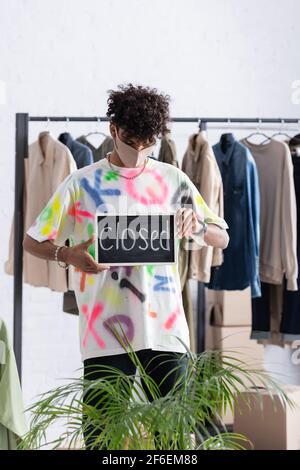 Stylish african american owner of clothes looking at