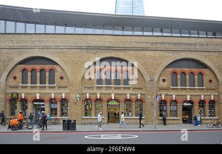 Fast food outlets McDonalds, Wasabi and Pure constructed within the Victorian arches beneath the newly refurbished London Bridge Station on Tooley St. Stock Photo