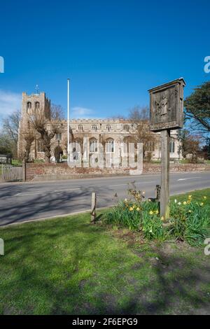 Coggeshall Essex, view in spring of St Peter Ad Vincula parish church and the village sign on Church Green in Coggeshall, Essex, UK Stock Photo