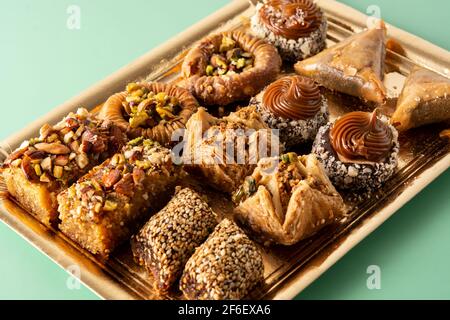 Assortment of Ramadan dessert baklava on green background Stock Photo
