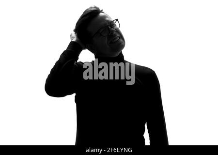 Silhouette of young man having headache pressing with hand on head isolated over white background. Stock Photo