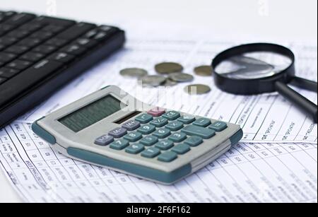 the concept of business and technology. magnifying glass, calculator, documents, securities on the office desk. Stock Photo