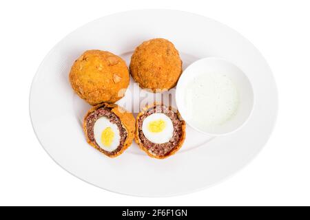 Baked scotch eggs with tartar sauce. Isolated on a white background. Stock Photo
