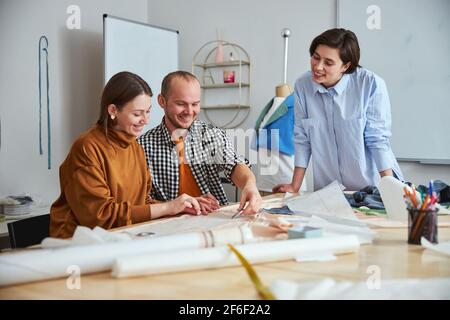 Positive friendly designers looking happy to work together Stock Photo