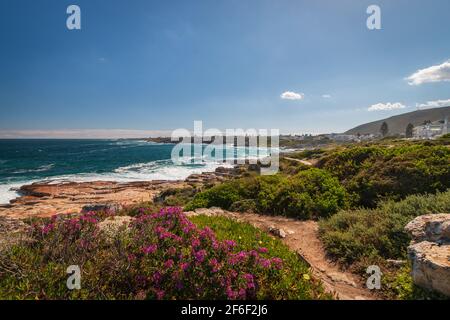 Scenic view of Hermanus and Walker Bay from cliff path near Cape Town, South Africa against blue sky with clouds Stock Photo