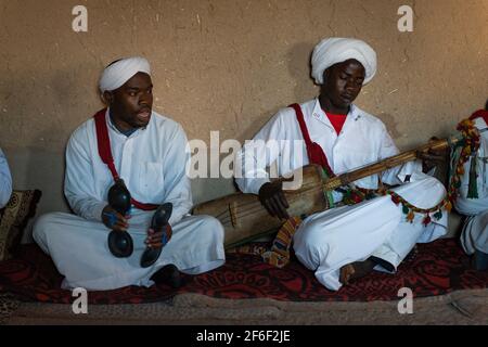 Khamlia, Morocco - April 12, 2016: A group of white dressed man playing traditional slave music, kown as Gnawa, in the village of Khamlia, in the west Stock Photo