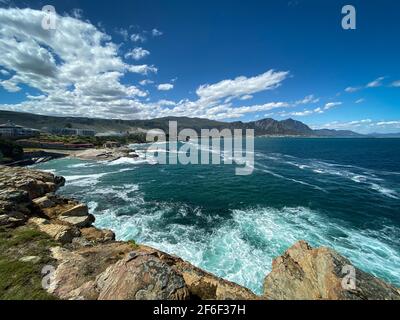 Panoramic view cityscape of Hermanus and Walker Bay seen from cliff path coastal trail at Atlantic Ocean, South Africa Stock Photo