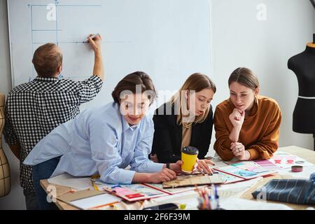 Confident creative fashion designers working in team Stock Photo