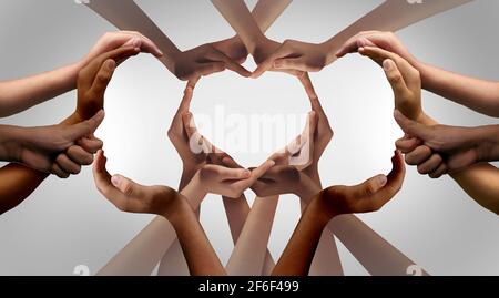 Unity and Togetherness or diversity partnership as heart hands in a group of diverse people connected together shaped as a support symbol. Stock Photo