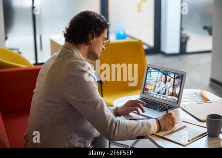 Attentive brunette businessman making notes during conference Stock Photo