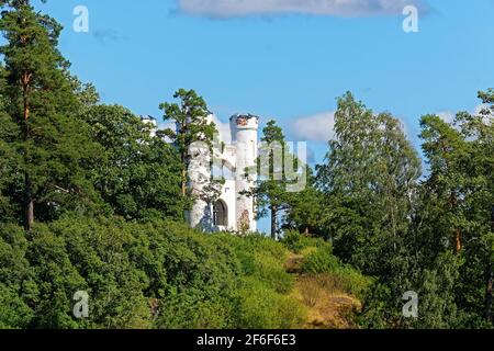 White turrets of the Chapel in Ludwigsburg Park mon repos in Vyborg on the background of blue sky. Stock Photo