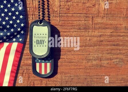 American flag and soldiers tags on wooden background.Veterans Day Concept. Stock Photo