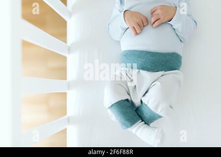 directly above view of four day old newborn baby boy in baby crib Stock Photo