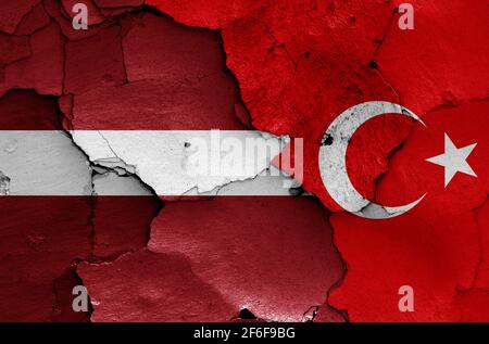 flags of Latvia and Turkey painted on cracked wall Stock Photo