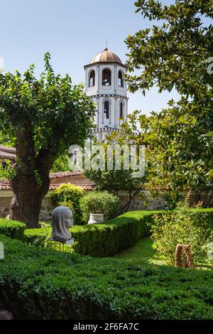 Garden of the Regional Ethnographic Museum Plovdiv, Bulgaria, with the bell tower of The Assumption of the Holy Virgin orthodox church visitble behind Stock Photo