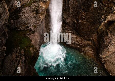 Moody image taken on a summer Johnston Canyon Upper Falls hike near Banff, Alberta, Canada. The turquoise water at the base of the waterfall makes it Stock Photo