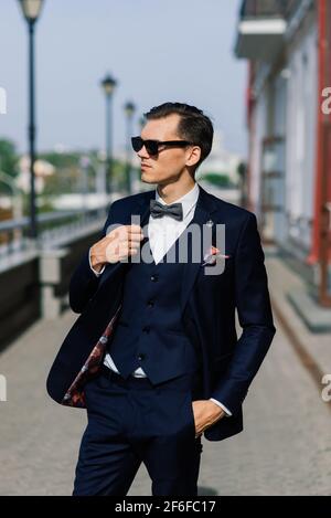 Portrait of an attractive young businessman in urban background wearing suit a necktie. Stock Photo