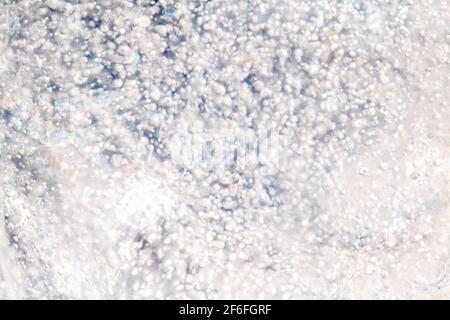 Bubbles of frozen air blurred in ice glow and sparkle in the sun Stock Photo
