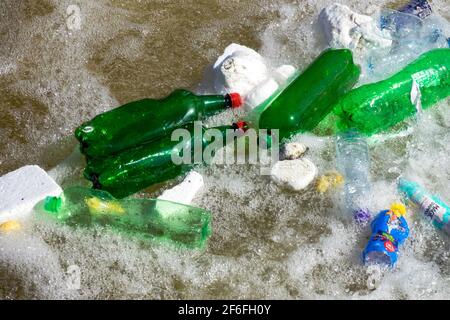 Water pollution, garbage plastic bottles floating in foamed level of river Stock Photo