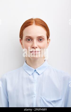 Young Smiling Woman Isolated On White Studio Background Model Woman With Hair Pulled Back, In Blue Formal Shirt. Closeup Portrait. Calm Human Emotion, Stock Photo