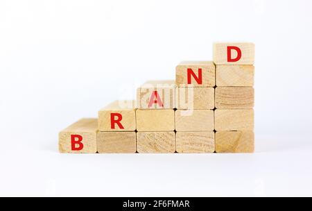 Brand symbol. Concept word 'brand' on wooden cubes on a beautiful white table. White background. Business and brand concept. Copy space.