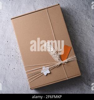 Close up on handmade gift present in cardboard box on the table Stock Photo