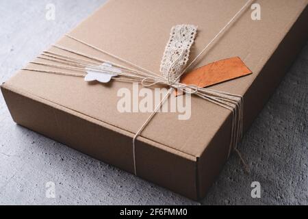 Close up on handmade gift present in cardboard box on the table Stock Photo