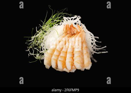 tiger shrimps, daikon, microgreen. Japanese food. Isolated on black background Stock Photo