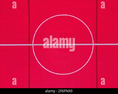 Plastic outdoor basketball court  floor, detail. Outdoor sport ground with red surface for playing basketball  in urban area, above. Stock Photo