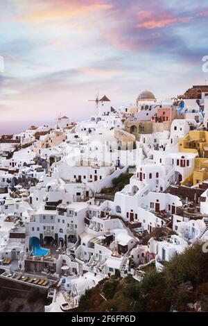 Oia village at colorful sunset, Santorini, Greece. Sunset view of the beautiful Greek town Oia in Santorini, Greece