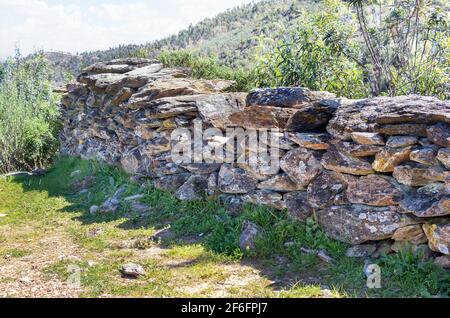 'Dry stone' or 'dry wall' wall. Characterized by the use of uncut stone in the construction of architectural structures for agricultural, livestock ac Stock Photo
