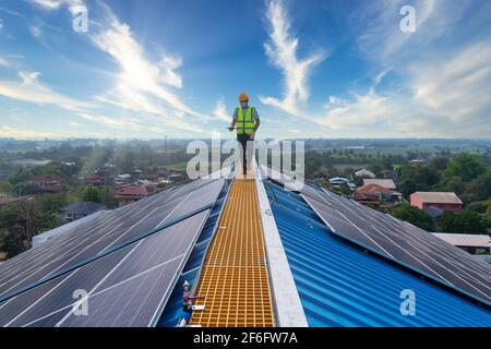 solar cells, technician working at solar power station on roof, solar energy, Stock Photo
