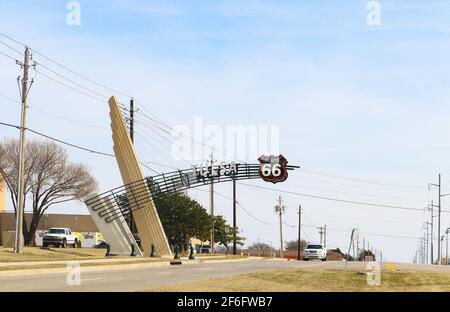 Art Deco Route 66 sign extending over highway by Daylight Donut warehouse leaving city to the east in Tulsa Oklahoma USA 3 9 2018 Stock Photo