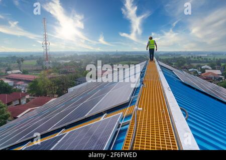 solar energy, engineering working on roof checking and maintenance in solar power plant , solar power plant to innovation of green energy for life Stock Photo
