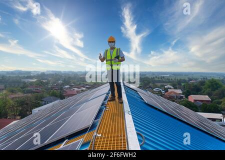 solar energy, Happy engineering working on roof checking and maintenance in solar power plant , solar power plant to innovation of green energy for li Stock Photo