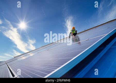 solar energy, engineering team working on roof checking and maintenance in solar power plant , solar power plant to innovation of green energy for lif Stock Photo