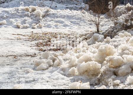 Early spring time dirty gray melted snow with sand pattern texture Stock Photo