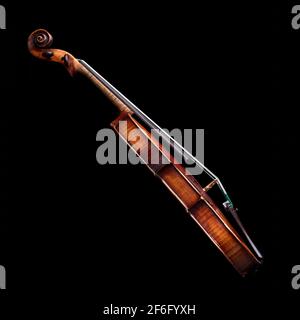 side view of a baroque violin isolated on black background Stock Photo