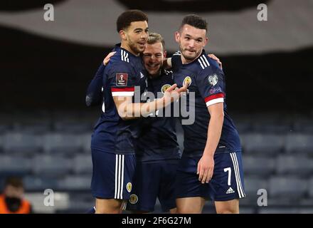 Scotland's Che Adams (left) celebrates scoring their side's third goal of the game with team-mates Ryan Fraser and John McGinn (right) during the 2022 FIFA World Cup Qualifying match at Hampden Park, Glasgow. Picture date: Wednesday March 31, 2021. Stock Photo