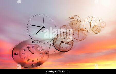Three clocks in bright sky. Time passing Stock Photo