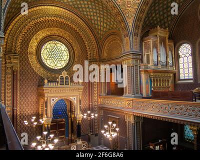 The Organ pipes and South window of the Spanish Synagogue in Prague: A large organ occupies the East balcony. The synagogue's uncurtained Torah Ark sits below a large stained glass window on the South wall of the Spanish Synagogue in Prague. Stock Photo