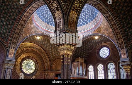 Arches, Domes and Windows in the Spanish Synagogue in Prague: Large decorated arches frame stained glass windows and the organ in this popular Prague museum and and Synagogue. Stock Photo
